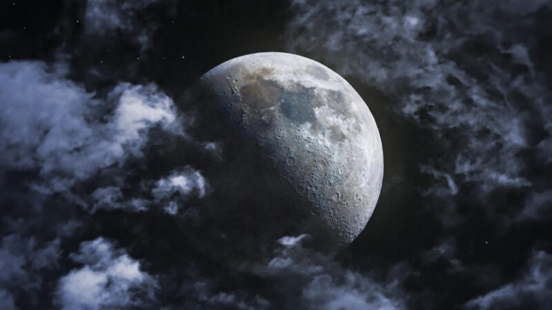 Cratered Moon Looms Over Dark Night Clouds wallpaper 4K