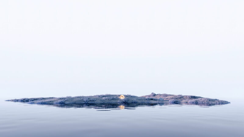 Moonlit Island Floating on Still Water wallpaper 4K