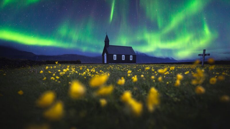 Northern Lights Dance Over Icelandic Chapel wallpaper 4K