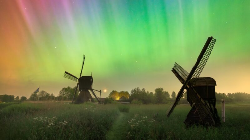 Northern Lights Swirl Around a Rural Windmill wallpaper 4K