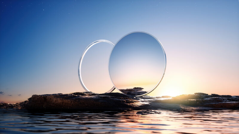 Reflective Spheres Mirroring a Sunset Shore wallpaper 4K