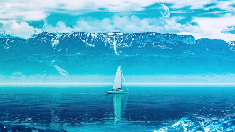 Sailing Boat Crossing Blue Ocean Mountains Ahead wallpaper 4K