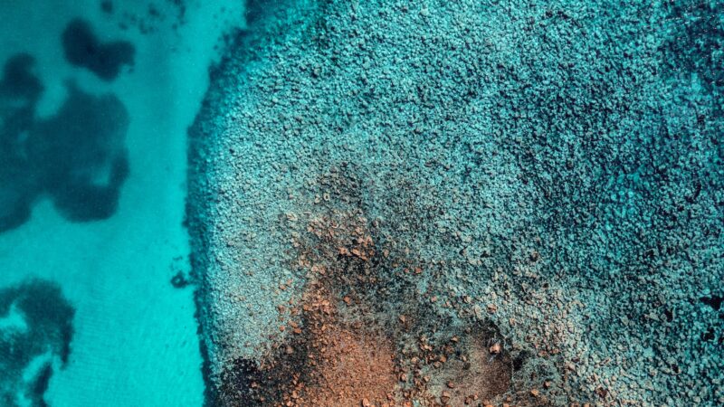 Tiny Rocky Island Turquoise Shallows Aerial iPhone Wallpaper 4K wallpaper 4K